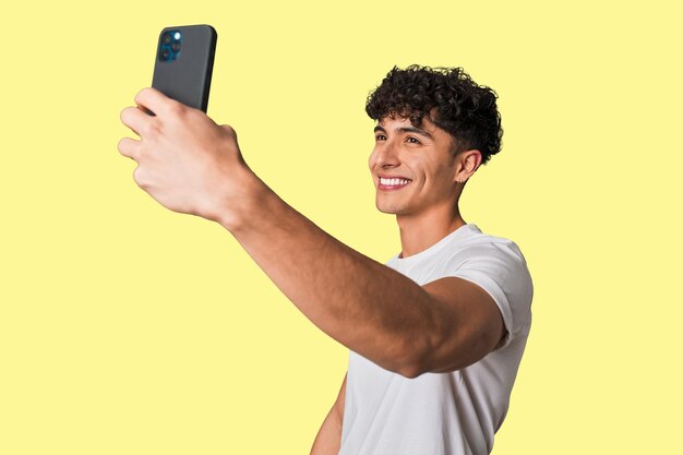 Capturing a smile Young man taking a selfie