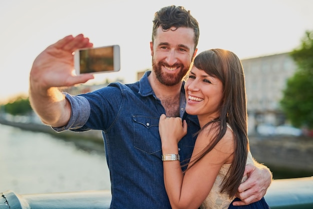 Capturing their love Cropped shot of an affectionate young couple taking selfies while on a date