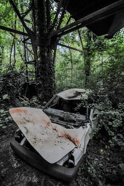 Car in abandoned industrial gravel quarry and sand stone\
refinery