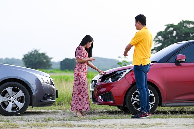 Car accident insurance.Male Female Drivers  After Traffic Accident.People  after a car crash and trying to find friendly agreement 