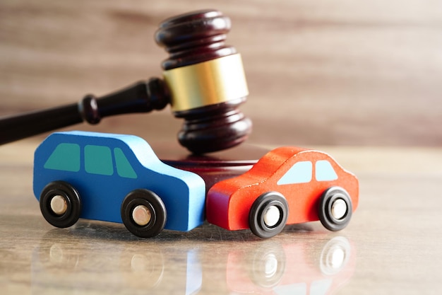 Photo car accident lawsuit and insurance judge hammer with car model