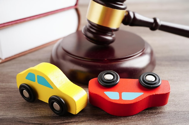 Car accident lawsuit and insurance Judge hammer with car modelxA