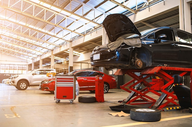 Car in automobile repair service center with soft-focus and over light in the background