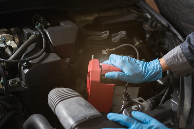 Car battery care Mechanic checking battery Closeup