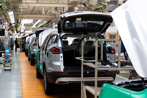 Car bodies are on assembly line factory for production of cars modern automotive industry electric