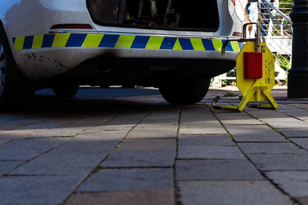 Car boot next to a police car in the city.