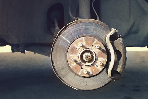 A car brake disc with stopping support without wheels closeup view.