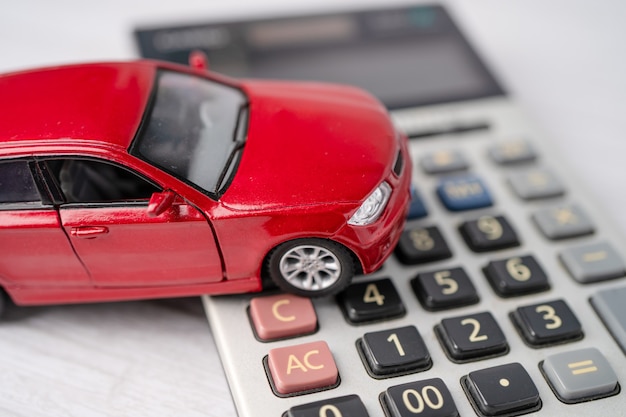 Car on calculator, Car loan, Finance, saving money, insurance and leasing time concepts.