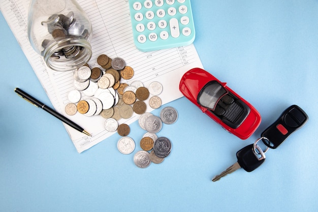 Car and calculator with coins on document