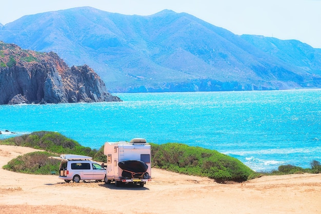 Car and Camper at Capo Pecora resort at the Mediterranean sea, Sardinia, Italy