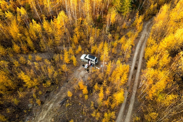 Car camping in autumn forest Drone wiev