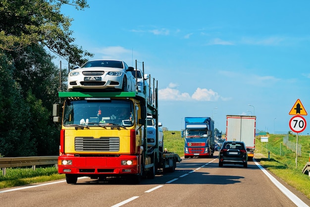 Car carrier on the road in Poland. Truck transporter