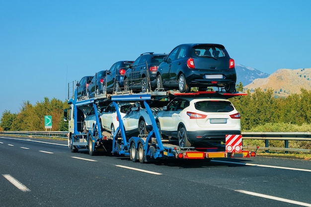 Car carrier at the road. Truck transporter