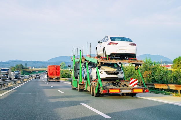 Car carrier truck in the asphalt highway in Poland. Truck transporter