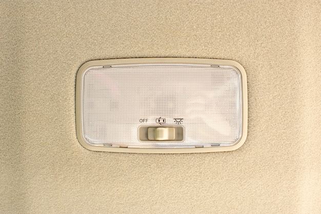 Photo car ceiling light with switch on interior of car.