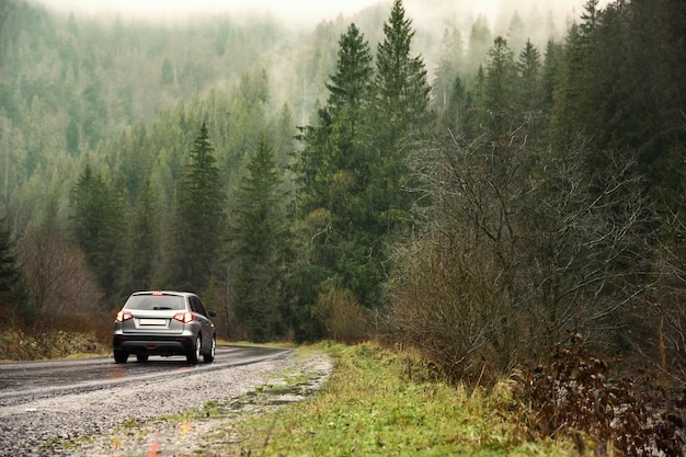 Car on country road in rainy weather