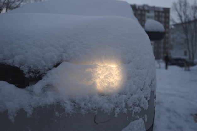 A car covered with snow after a snowfall