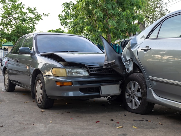 Car crash accident on street with wreck and damaged automobiles.