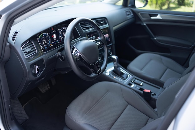 Car dashboard with a digital touchscreen steering wheel of a\
electric vehicle interior cockpit