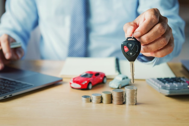 Car dealer hand holding key