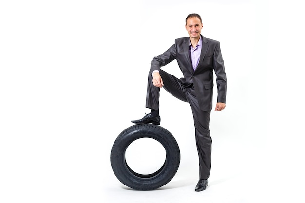 Car dealer man over tire tire background. Auto maintenance.