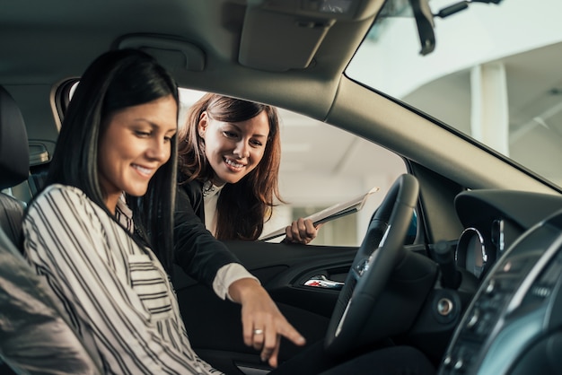 Car dealer showing vehicle to client.