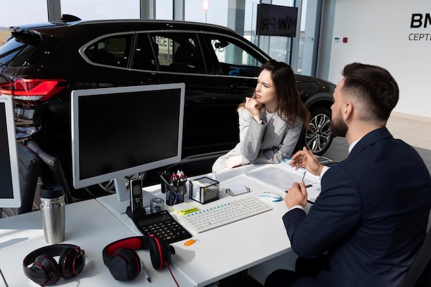 Car dealership manager advises young woman from buying new car the concept of buying a car on lease