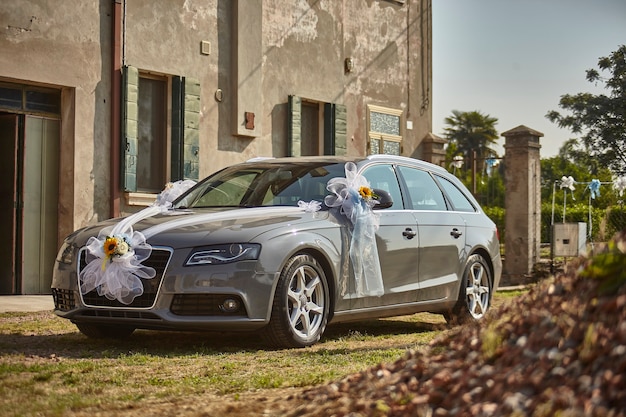 Car decorated and adorned with bows and flowers for the wedding The car of the couple
