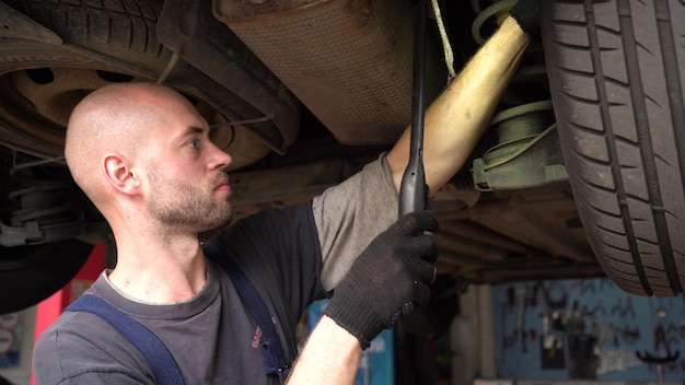 Car diagnostics an auto mechanic inspects a car auto repair shop breaking transmission