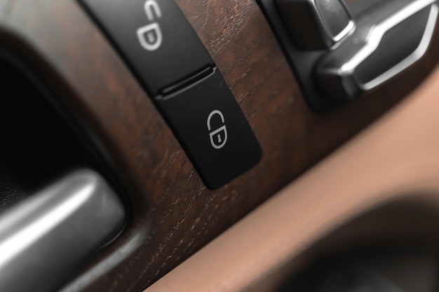 Car door lock switch closeup car lock buttons in modern luxury\
vehicle with leather interior background photo