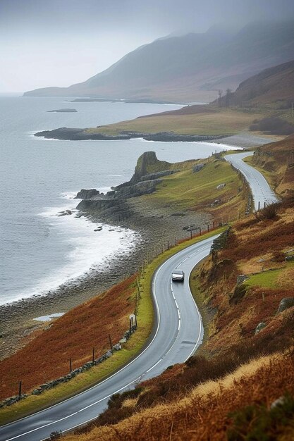 Photo a car driving down a road next to a body of water