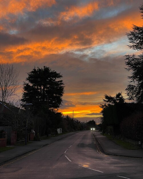 Car driving on the road in residential area during beautiful sunrise