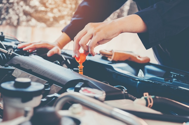 Car Engine oil mechanic working in auto repair service