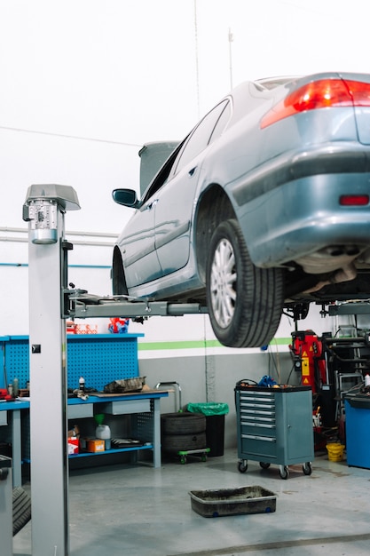 Car in garage of auto repair service shop