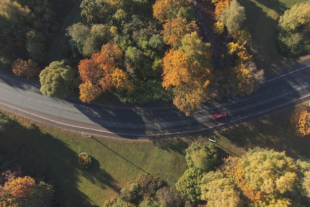 The car goes through a road turn Air view Autumn entourage