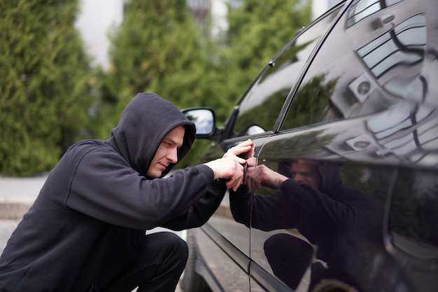 Photo car hijacks  auto thief black balaclava