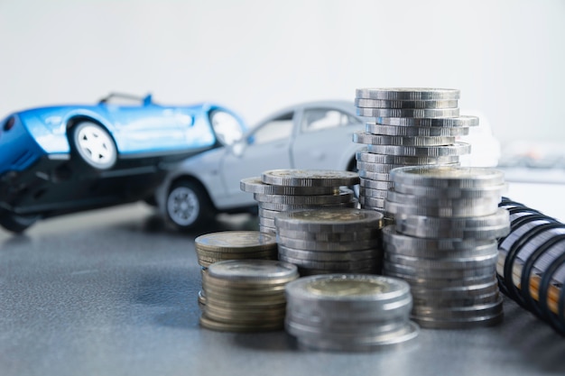 Car insurance and car service with stack of coins.