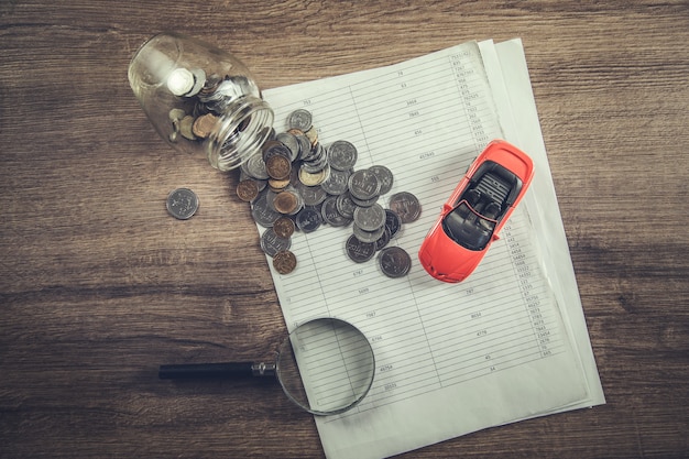 Car insurance with coins on the document