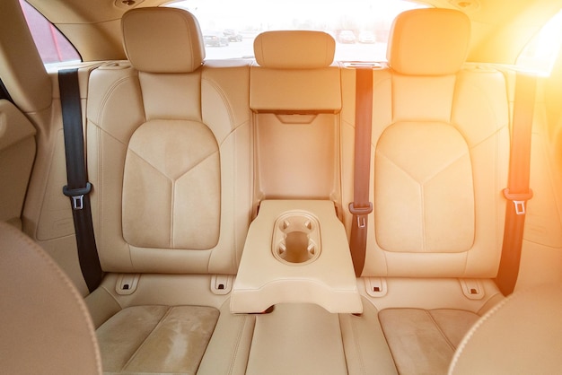 Photo car interior luxury beige comfortable seats steering wheel dashboard climate control speedometer display wood decoration light