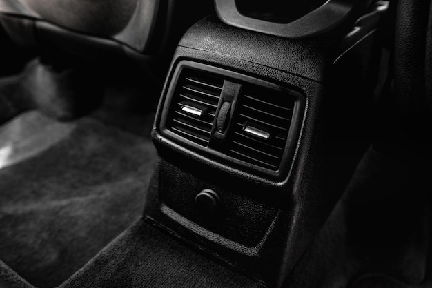 Car interior with climate controls for back seats.