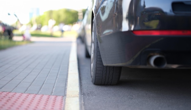 Car is parked near yellow median strip closeup