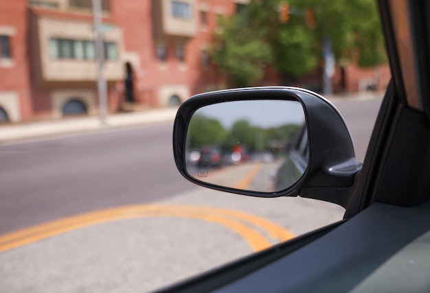 A car is visible in the mirror of a car.