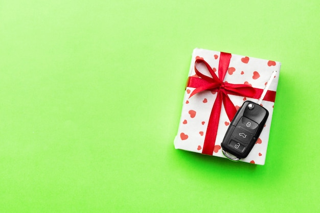 car key on present with ribbon on green