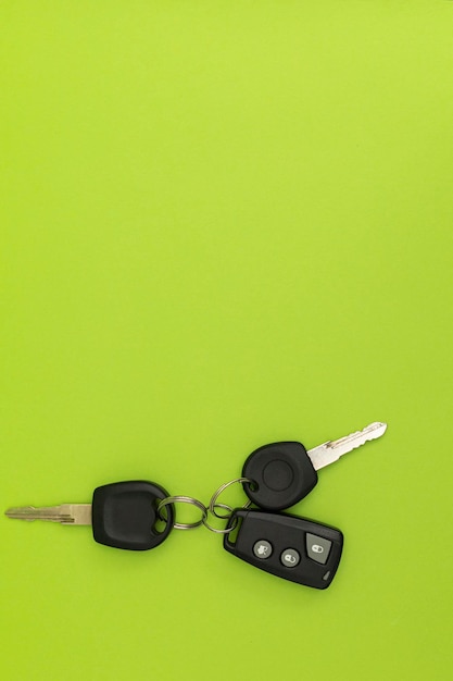 Car keys on green background