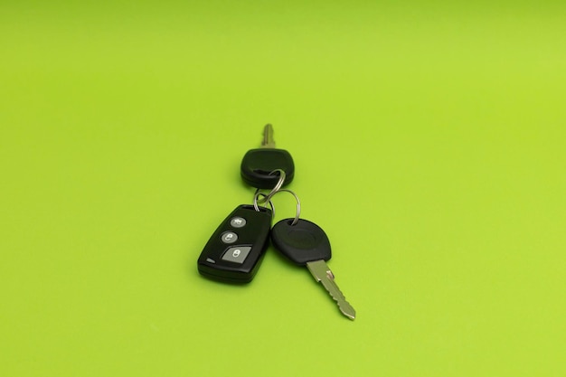 Car keys on green background