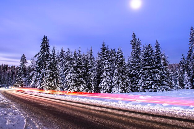 Car light trials in winter road in mountains