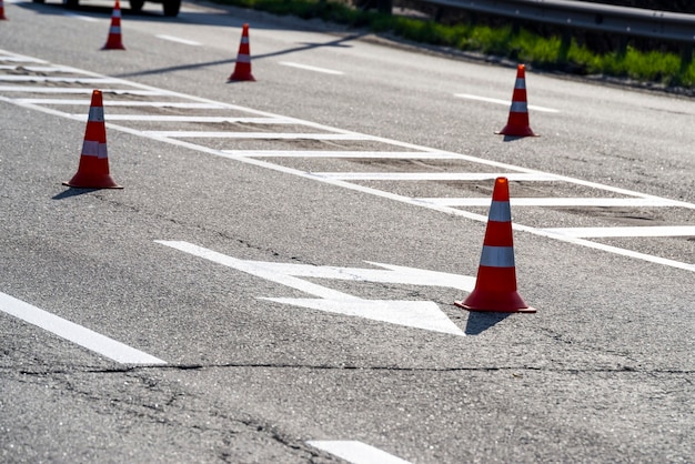 Car markings on asphalt with cones, signs for controlling the direction of movement