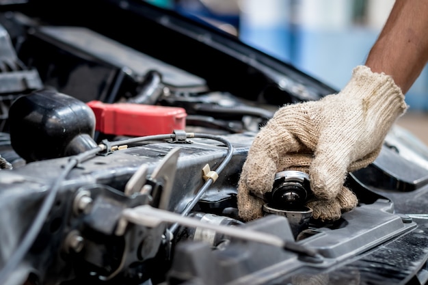 Car mechanic are opening the radiator cap