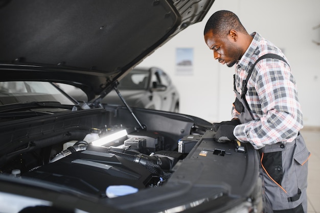 Car mechanic in auto repair service
