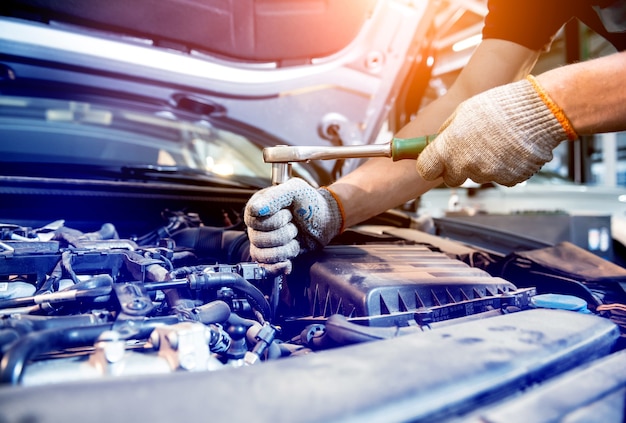 Photo car mechanic repair engine at service station. car repair.